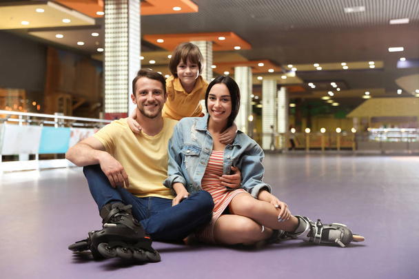 Happy family spending time at roller skating rink - Zdjęcie, obraz
