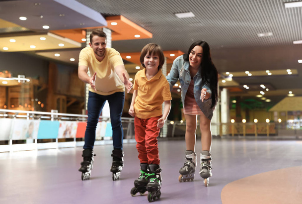 Happy family spending time at roller skating rink - Фото, зображення