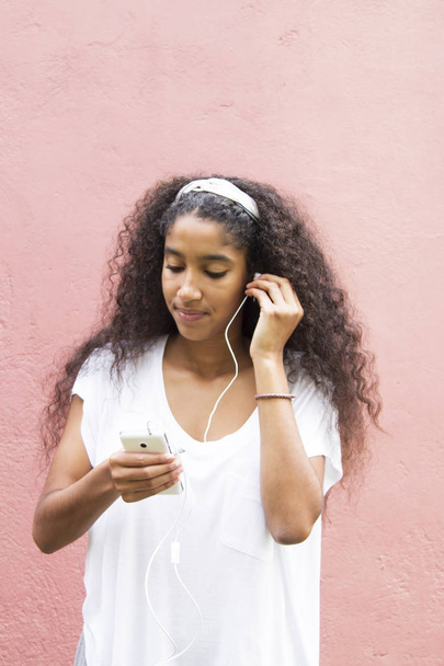 Afro young woman listening to music - Valokuva, kuva