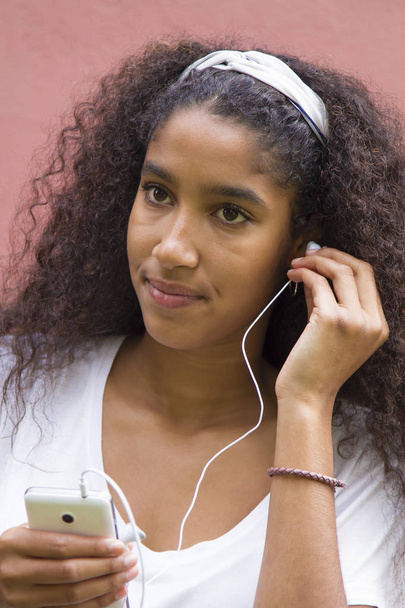 Afro young woman listening to music - 写真・画像