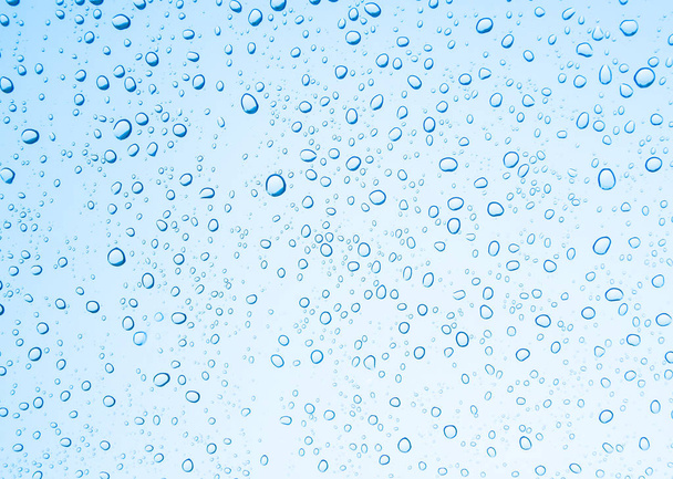Water drops on glass on blue sky background  - Photo, Image