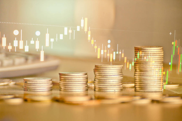 Stacks of golden coins with trading graph in background , financial investment concept  - Photo, Image