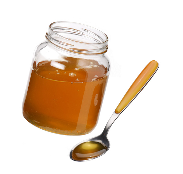 Honey in the pot and a spoon - Φωτογραφία, εικόνα