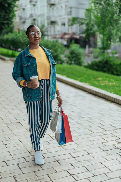Young afro american woman is walking outdoors - Zdjęcie, obraz