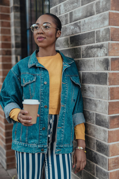Young afro-american woman with coffee cup in hands - Photo, image