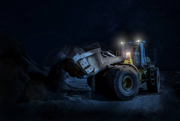 Τροχοφόρος φορτωτής ορυχείων Σκούπινγκ χαλίκι σε ένα νυχτερινό χρόνο κατασκευής - Φωτογραφία, εικόνα