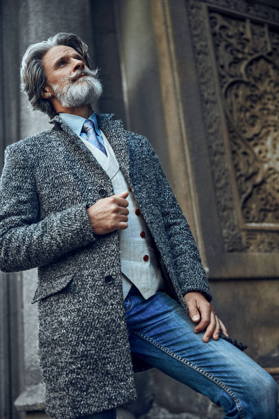 Thoughtful mature bearded man outdoors stock photo - Фото, зображення