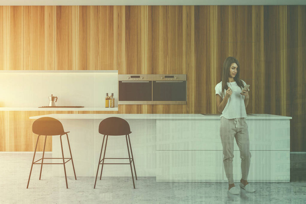 Woman in wooden kitchen with bar - Φωτογραφία, εικόνα