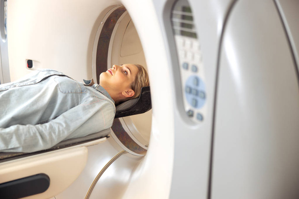 Female patient having CT scan test at radiology clinic - Fotó, kép