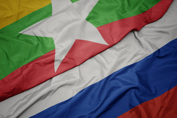 acenando bandeira colorida da Rússia e bandeira nacional de Mianmar
. - Foto, Imagem