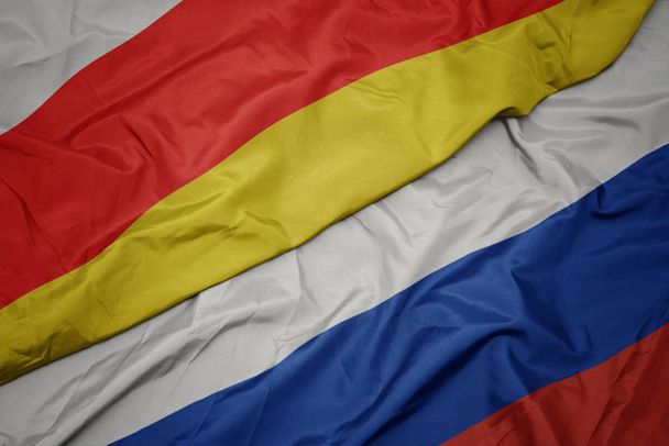 schwenken bunte Flagge Russlands und Nationalflagge Südossetiens. - Foto, Bild