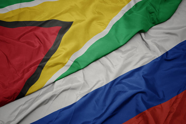 Orosz zászló és Guyana nemzeti zászlaja. - Fotó, kép
