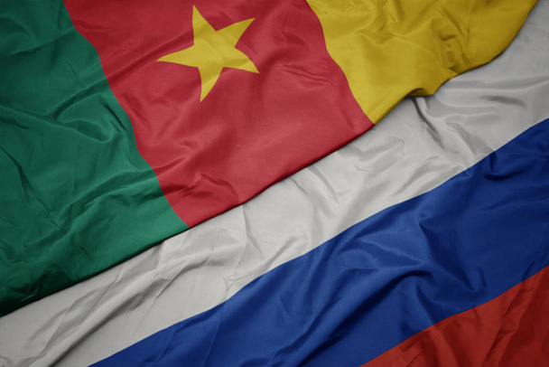 ondeando colorida bandera de Rusia y bandera nacional de Camerún
. - Foto, imagen