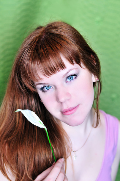 Redheaded girl with white flower - Photo, image