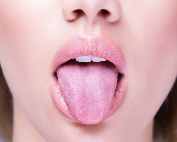 Close up shot of an open mouth and a healthy human tongue. - Photo, Image