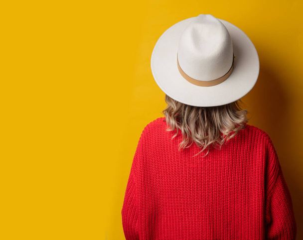 Young woman in hat and red sweater - Photo, Image