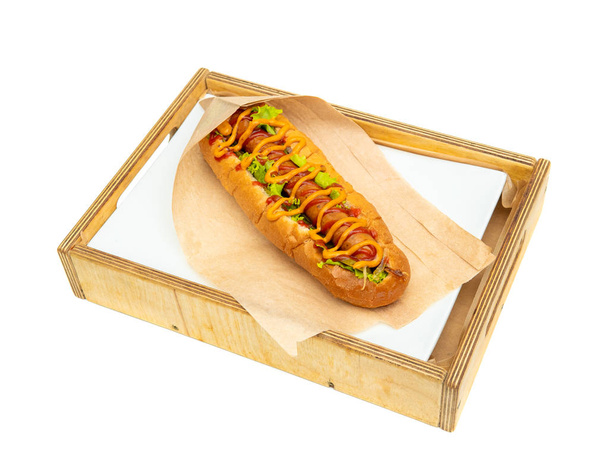 Hot dog with salad and cucumbers with tomato ketchup and mustard - Фото, изображение