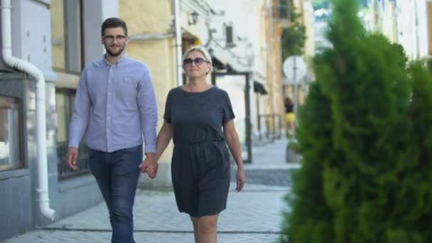 Aged star walking with young man, yellow press journalist taking photo, scandal - Video, Çekim