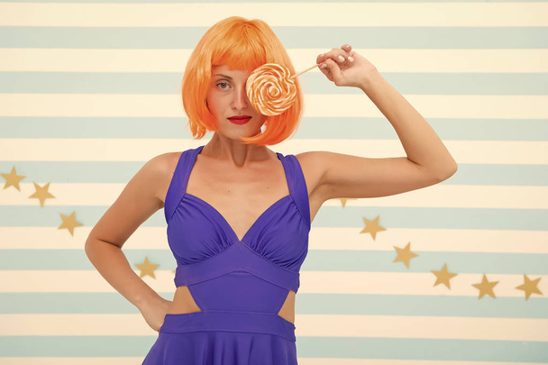 Fashion girl with orange hair having fun. Crazy girl in playful mood. happy pinup model with lollipop in hand. Cool girl with lollipop. Sexy woman. party time. Sweet look. So much fun - 写真・画像