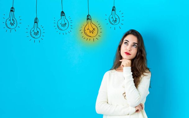 Idea light bulbs with young woman - Фото, изображение