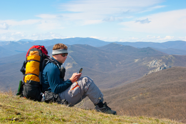 Hiker using mobile device - Photo, Image