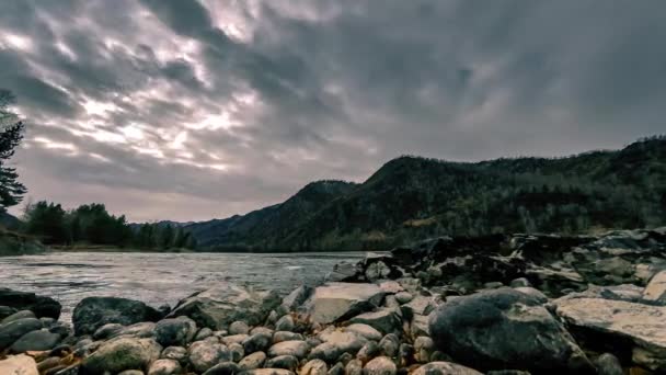 Time lapse shot of a river near mountain forest. Huge rocks and fast clouds movenings. Horizontal slider movement - Video, Çekim