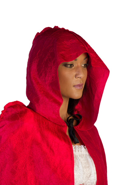 Little red riding hood standing peeping out underneath her hood - Photo, Image