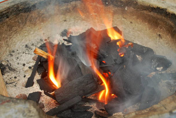 Ancient fire by using charcoal from wood. - Photo, Image