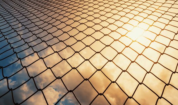 Wire mesh with sky background and light shines, barrier wire obstacles concept - Photo, Image