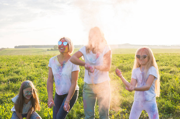 Holiday, summer and fun concept - Group of people dancing in field at holi festival - Valokuva, kuva