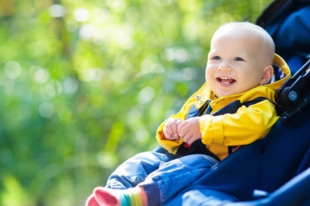 Baby boy in stroller in autumn park - Valokuva, kuva