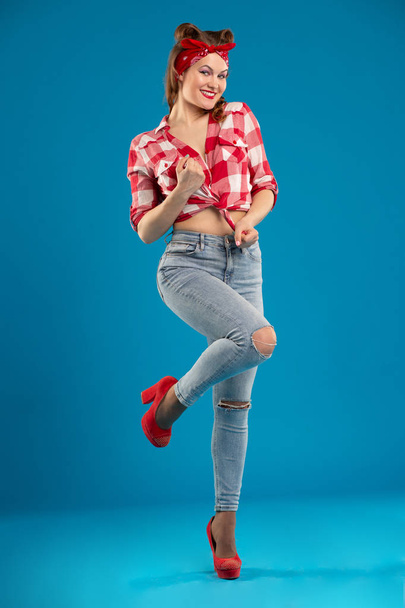 Beautiful sexy woman in the style of Pin-Up knotted on an unbuttoned plaid shirt - Photo, image