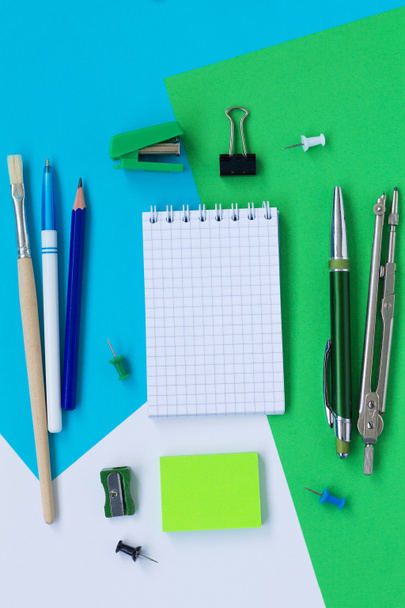 set of office tools isolated on blue, green and white background top view. back to school - 写真・画像