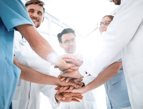 group of doctors with their hands folded together - Fotografie, Obrázek