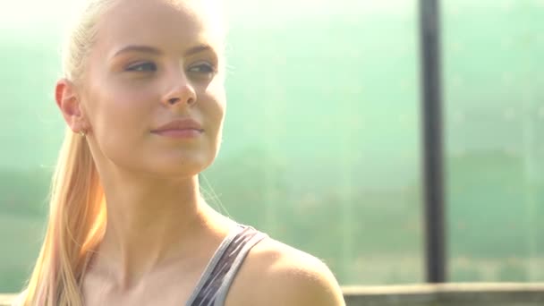 Young, attractive and sporty blond girl. Outdoor portrait. Healthcare and lifestyle. - Video