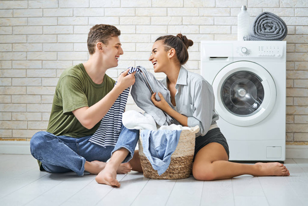 loving couple is doing laundry - Фото, изображение