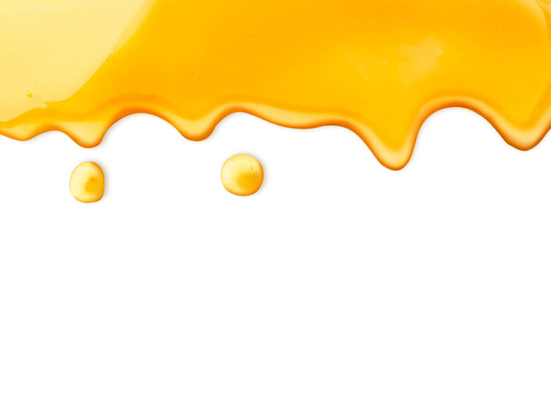 Drips of honey on a white. The view of the top. - Photo, Image