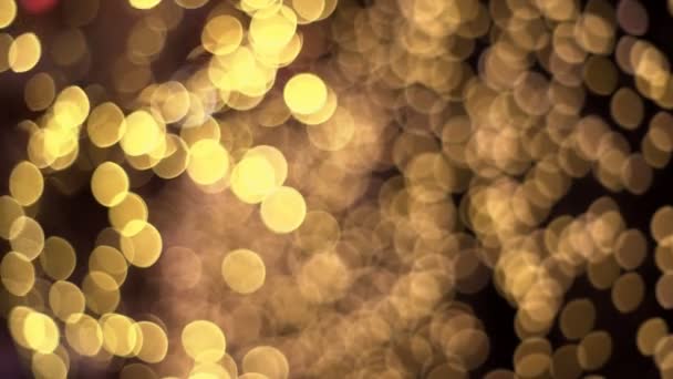 absztrakt homályos Gold csillogás bokeh hatása a sötét háttér - Felvétel, videó