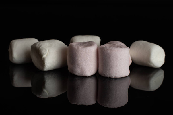Sweet fluffy marshmallow isolated on black glass - Фото, изображение