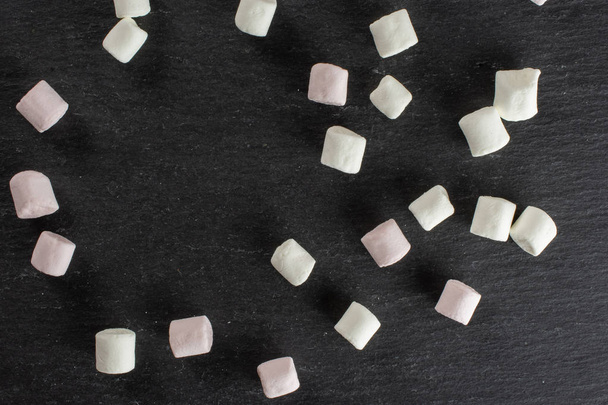 Sweet fluffy marshmallow on grey stone - Photo, Image