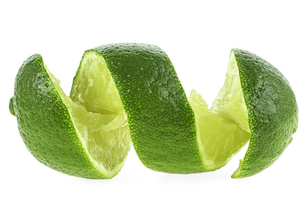 Cut lime in shape of a spiral on white background - Fotó, kép