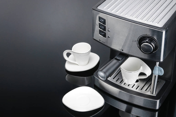 Espresso coffee machine on the grey mirror background with copy  - Foto, afbeelding