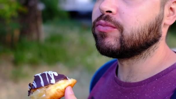 Bearded man eating tasty chocolate cake, unhealthy nutrition, slow motion, diet - Footage, Video