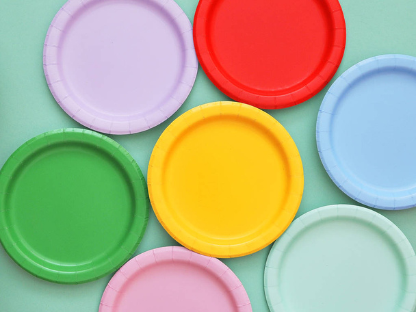 Colorful paper plates on light background. - Foto, afbeelding