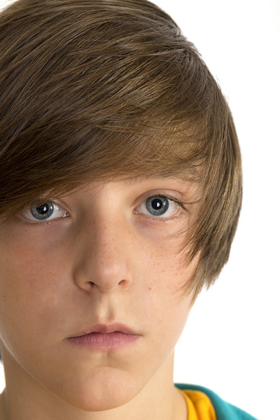 Closeup of a cute teenage boy looking into the camera, isolated - Photo, Image