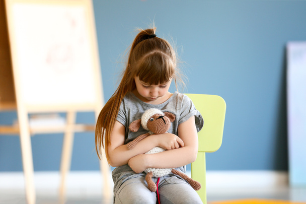 Sad little girl with autistic disorder in playroom - Photo, Image
