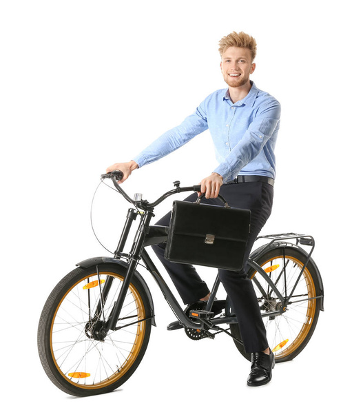 Young businessman riding bicycle against white background - Photo, image