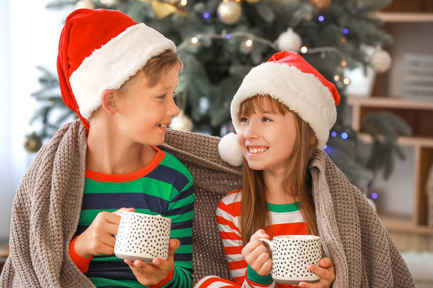 Little children drinking hot chocolate at home on Christmas eve - Fotografie, Obrázek