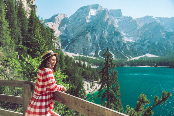 woman standing in front of lake in mountains - Foto, Bild