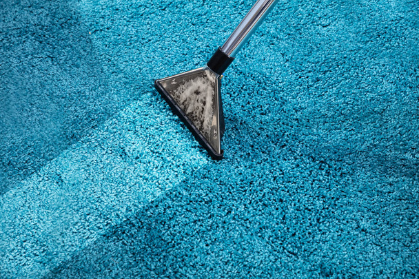 Close-up Of A Person Cleaning Carpet With Vacuum Cleaner - Photo, image